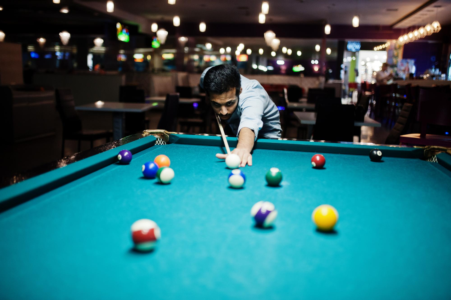 Man playing pool in a bar